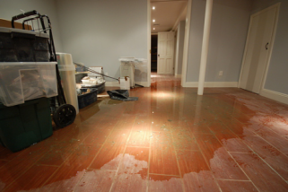 Plumbing system failure causes water damage on hardwood floors